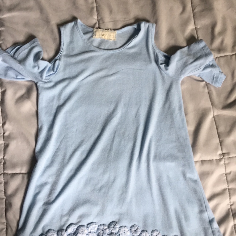 Baby blue shirt has flowers on bottom